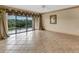 Spacious living room with tile floors and sliding glass doors to balcony at 1695 Pinellas Bayway S # D1, Tierra Verde, FL 33715