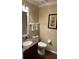 Updated powder room with granite vanity and dark wood cabinetry at 1743 Arabian Ln, Palm Harbor, FL 34685