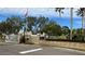 Gated community entrance with landscaping and signage at 1743 Arabian Ln, Palm Harbor, FL 34685