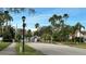 Community entrance with palm trees and a stop sign at 1743 Arabian Ln, Palm Harbor, FL 34685