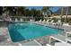Inviting community pool with lounge chairs at 1743 Arabian Ln, Palm Harbor, FL 34685