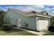 Well-maintained house exterior, featuring a two-car garage and nicely landscaped yard at 1743 Arabian Ln, Palm Harbor, FL 34685