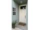Inviting front door entrance with a welcome mat and landscaping at 1743 Arabian Ln, Palm Harbor, FL 34685