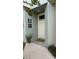 Front door entrance with a welcome mat and landscaping at 1743 Arabian Ln, Palm Harbor, FL 34685