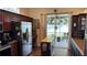 Kitchen with island, stainless steel appliances & access to backyard at 1743 Arabian Ln, Palm Harbor, FL 34685