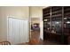 Home office with built-in shelving and view into living area at 1743 Arabian Ln, Palm Harbor, FL 34685