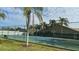 Community tennis court with surrounding fence and landscaping at 1743 Arabian Ln, Palm Harbor, FL 34685