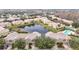 Aerial view of community, showcasing lake, pool, and townhouses at 17523 Stinchar Dr # 17523, Land O Lakes, FL 34638