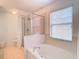 Bathroom with bathtub, shower, and window at 17523 Stinchar Dr # 17523, Land O Lakes, FL 34638