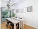 Bright dining room with white table, black chairs, and modern light fixture at 17523 Stinchar Dr # 17523, Land O Lakes, FL 34638