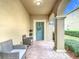 Covered entryway with teal door and brick flooring at 17523 Stinchar Dr # 17523, Land O Lakes, FL 34638