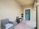 Front entry with teal door, two wicker chairs, and a brick floor at 17523 Stinchar Dr # 17523, Land O Lakes, FL 34638
