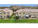 View of two townhouses with screened patios and landscaping at 17523 Stinchar Dr # 17523, Land O Lakes, FL 34638