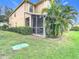 View of house exterior showcasing the screened patio and landscaping at 17523 Stinchar Dr # 17523, Land O Lakes, FL 34638