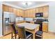 Kitchen with light wood cabinets, stainless steel appliances, and an island at 17523 Stinchar Dr # 17523, Land O Lakes, FL 34638