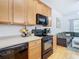 Kitchen with light wood cabinets and black appliances at 17523 Stinchar Dr # 17523, Land O Lakes, FL 34638
