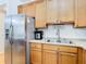 Modern kitchen with stainless steel appliances and light wood cabinets at 17523 Stinchar Dr # 17523, Land O Lakes, FL 34638