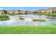 Community lake view with lush landscaping and townhouses at 17523 Stinchar Dr # 17523, Land O Lakes, FL 34638