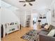 Living room with gray sofa, patterned rug, and staircase at 17523 Stinchar Dr # 17523, Land O Lakes, FL 34638
