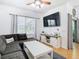 Living room features a sectional sofa, large TV and white media cabinet at 17523 Stinchar Dr # 17523, Land O Lakes, FL 34638