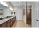 Double vanity bathroom with granite countertop and large shower at 1861 Pacific Dunes Dr, Sun City Center, FL 33573