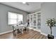 Home office features built-in shelving, a desk, and hardwood floors at 1861 Pacific Dunes Dr, Sun City Center, FL 33573