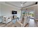 Relaxing living room, featuring recessed lighting and sliding glass doors at 1861 Pacific Dunes Dr, Sun City Center, FL 33573