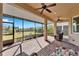 Relaxing screened porch with brick floor, ceiling fan, and view of backyard at 1861 Pacific Dunes Dr, Sun City Center, FL 33573