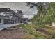 Landscaped backyard with screened pool area at 195 Rusk Cir, Spring Hill, FL 34606