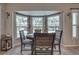 Cozy dining area with round table and chairs, overlooking the pool at 195 Rusk Cir, Spring Hill, FL 34606