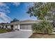 Single story home with attached garage and lush landscaping at 195 Rusk Cir, Spring Hill, FL 34606