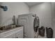 Bright laundry room featuring a washer, dryer, and utility sink at 195 Rusk Cir, Spring Hill, FL 34606