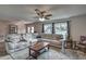 Expansive living area with sectional sofa, a large window, and wood-look tile floors at 195 Rusk Cir, Spring Hill, FL 34606