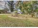 Landscaped yard with mature trees surrounding the house at 195 Rusk Cir, Spring Hill, FL 34606