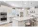 Modern kitchen with white cabinets, stainless steel appliances, and large island at 20011 Umbria Hill Dr, Tampa, FL 33647