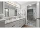 Elegant bathroom with double vanity and marble shower at 2556 Pine Cove Ln, Clearwater, FL 33761