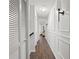 Bright hallway with wood flooring and wainscoting at 2556 Pine Cove Ln, Clearwater, FL 33761