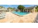 Community pool with lounge chairs and cabana at 3157 Landmark Dr # 411, Clearwater, FL 33761