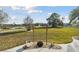 Landscaped backyard with a pond and walking path view at 326 Caloosa Woods Ln, Sun City Center, FL 33573