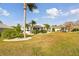 Peaceful backyard view showcasing the home's exterior and landscaping at 326 Caloosa Woods Ln, Sun City Center, FL 33573