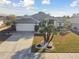 Single-story home with a two-car garage and palm trees at 326 Caloosa Woods Ln, Sun City Center, FL 33573
