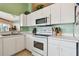 Bright eat-in kitchen, featuring white cabinetry, modern appliances, and ample counter space at 326 Caloosa Woods Ln, Sun City Center, FL 33573