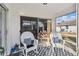 Cozy screened-in porch with rocking chairs and a view of the yard at 326 Caloosa Woods Ln, Sun City Center, FL 33573