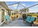 Relaxing screened porch with wicker furniture overlooking the golf course at 326 Caloosa Woods Ln, Sun City Center, FL 33573