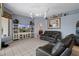 Gathering room featuring leather sofas, built-in shelving, and a large TV at 3363 Cedar Crest Loop, Spring Hill, FL 34609