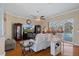 Living room with hardwood floors, a fireplace, and a large TV at 3363 Cedar Crest Loop, Spring Hill, FL 34609