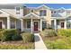 Two-story townhome with a red door and well-maintained landscaping at 3409 Santa Rita Ln, Land O Lakes, FL 34639