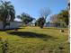 Landscaped backyard with trees and grass at 4415 Great Lakes N Dr, Clearwater, FL 33762