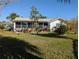 Spacious backyard with patio and lush tropical landscaping at 4415 Great Lakes N Dr, Clearwater, FL 33762
