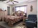 Bedroom with large bed, ceiling fan and armchair at 4415 Great Lakes N Dr, Clearwater, FL 33762